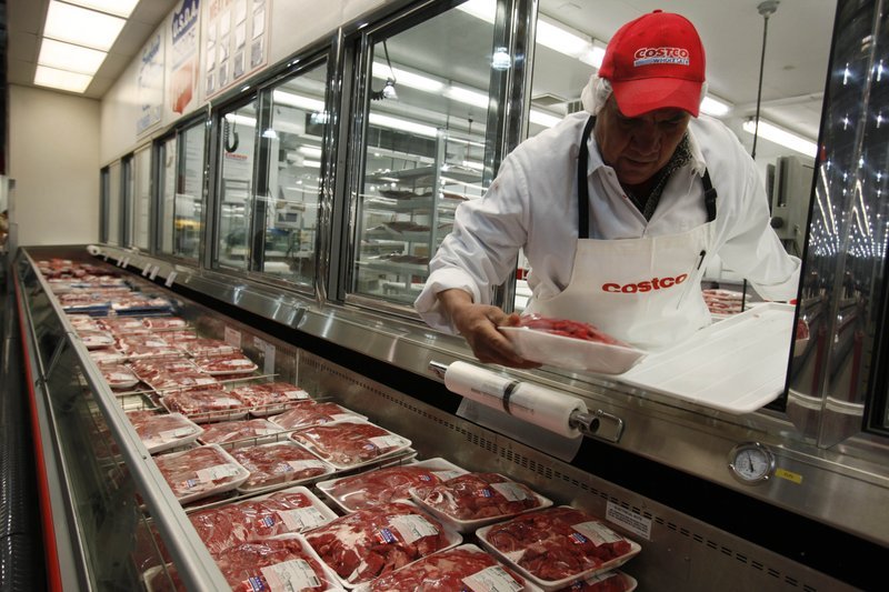 In this Dec. 8, 2009 file photo, a butcher places beef on display at Costco in Mountain View, Calif. U.S. meat supplies are dwindling due to coronavirus-related production shutdowns. As a result, some stores like Costco and restaurants like Wendy's are limiting sales. U.S. beef and pork processing capacity is down 40% from last year. On Monday, May 4, 2020 nearly 20% of U.S. Costco, Sam's Club, Hy-Vee and Kroger are limiting purchases of meat to avoid panic buying. (AP Photo/Paul Sakuma, file) story.lead_photo.caption