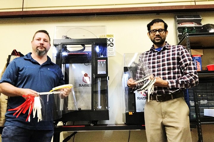 Jeff Sumner, left, engineering shop machinist, and Dr. Mahbub Ahmed, associate professor of engineering, display face shields produced at Southern Arkansas University for distribution to area healthcare workers.