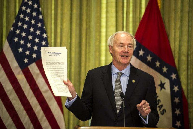 “We still have an emergency situation in Arkansas and across our nation that everyone is familiar with,” Gov. Asa Hutchinson cautioned Tuesday as he eased some restrictions while extending the public health emergency for 45 more days. More photos at arkansasonline.com/56gov/. (Arkansas Democrat-Gazette/Stephen Swofford)
