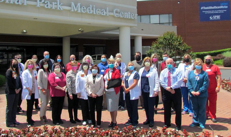 National Park Medical Center's leadership team stands in front of the hospital which now features a "Thank A Healthcare Hero" banner in recognition of the "heroic efforts their staff has put forth over the past several weeks." - Submitted photo