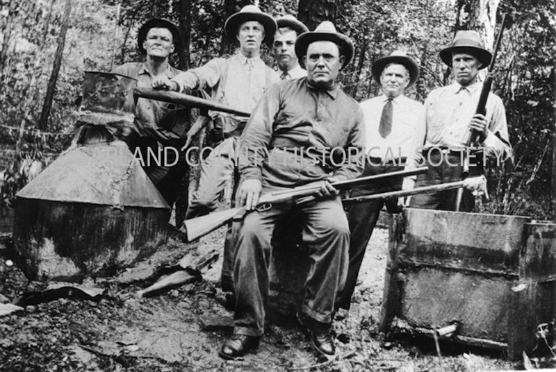 Law officers at captured still, circa 1927. Prohibition agents Dave Brown and John Hopper, Deputy Marion Anderson, Sheriff Garland Van Sickle, Deputies Jim Floyd and Will Lowe. -Photo courtesy of the Garland County Historical Society