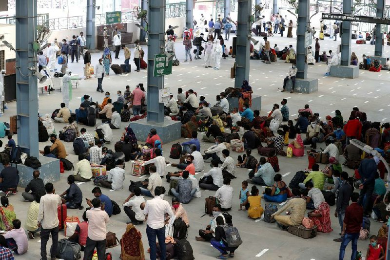 Migrant laborers, who arrived from Gujarat state on a train, rest in Prayagraj, India, before proceeding to their villages Wednesday.
(AP/Rajesh Kumar Singh)