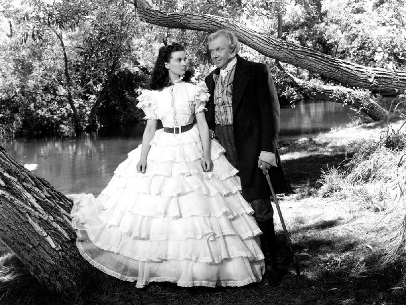 Gerald O’Hara (Thomas Mitchell, right) counsels willful young daughter Scarlett (Vivien Leigh) in an early scene from the Civil War epic Gone With the Wind.