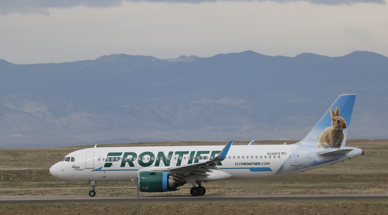 In this April 23, 2020 photo a Frontier Airlines jetliner taxis to a runway for take off from Denver International Airport in Denver. Lawmakers on Capitol Hill lashed out Wednesday, May 6, 2020 against Frontier Airlines over the budget carrier's move to charge passengers extra to guarantee they will sit next to an empty middle seat while flying during the coronavirus outbreak. (AP Photo/David Zalubowski)