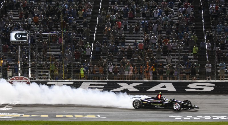 FILE - In this June 8, 2019, file photo, Josef Newgarden celebrates winning the IndyCar auto race at Texas Motor Speedway in Fort Worth, Texas. IndyCar has gotten the green flag to finally start its season in Texas. The race will be run June 6 without spectators at Texas Motor Speedway. (AP Photo/Randy Holt, File)