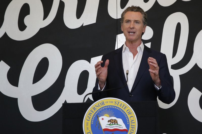 FILE - In this May 5, 2020 file photo, California Gov. Gavin Newsom discusses his plan for the gradual reopening of California businesses during a news conference at the Display California store in Sacramento, Calif. Newsom's administration is projecting a $54.3 billion budget deficit because of tax losses and expenses related to the coronavirus.(AP Photo/Rich Pedroncelli, Pool, File)