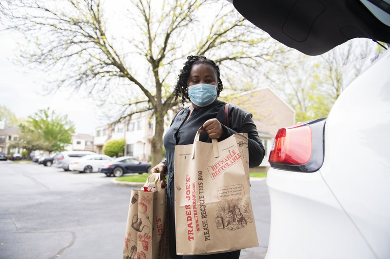 Ilanne Dubois, a 36-year-old single mother who was laid off in mid-March, completes her grocery shopping in New York. (The Washington Post by Michael Noble, Jr)