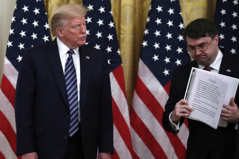 President Donald Trump watches as Veterans Affairs Secretary Robert Wilkie walks away after speaking about protecting seniors in the East Room of the White House on April 30, in Washington. - AP Photo/Alex Brandon