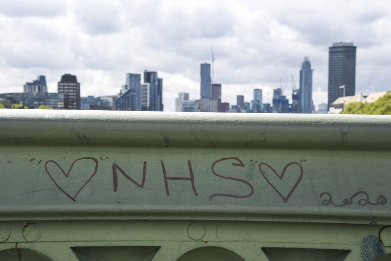 FILE - In this Friday, May 1, 2020 file photo, a message in support of the National Health Service (NHS) is written on Westminster Bridge, as the country continues its lockdown to curb the spread of coronavirus, in London. The virus outbreak is straining social safety nets across the globe - and underlining sharp differences in approach between wealthy societies such as the United States and Europe. In Europe, the collapse in business activity is triggering wage support programs that are keeping millions on the job, for now.  (AP Photo/Alberto Pezzali, File)