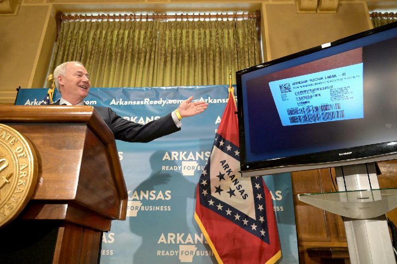 During his briefing Tuesday, Gov. Asa Hutchinson shows an image of a shipment of remdesivir, which has been given emergency approval for use in acute cases of covid-19. Hutchinson said the state had received enough of the drug for 50 patients. More photos at arkansasonline.com/513gov/. (Arkansas Democrat-Gazette/Stephen Swofford) 