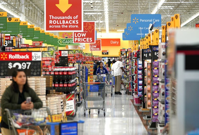 In this Nov. 9, 2018, file photo shoppers walk through the isles at a Walmart Supercenter in Houston. (AP Photo/David J. Phillip, File)