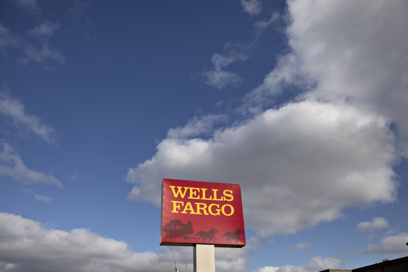 Signage is displayed outside a Wells Fargo &amp; Co. bank branch in Rock Island, Illinois. MUST CREDIT: Bloomberg photo by Daniel Acker