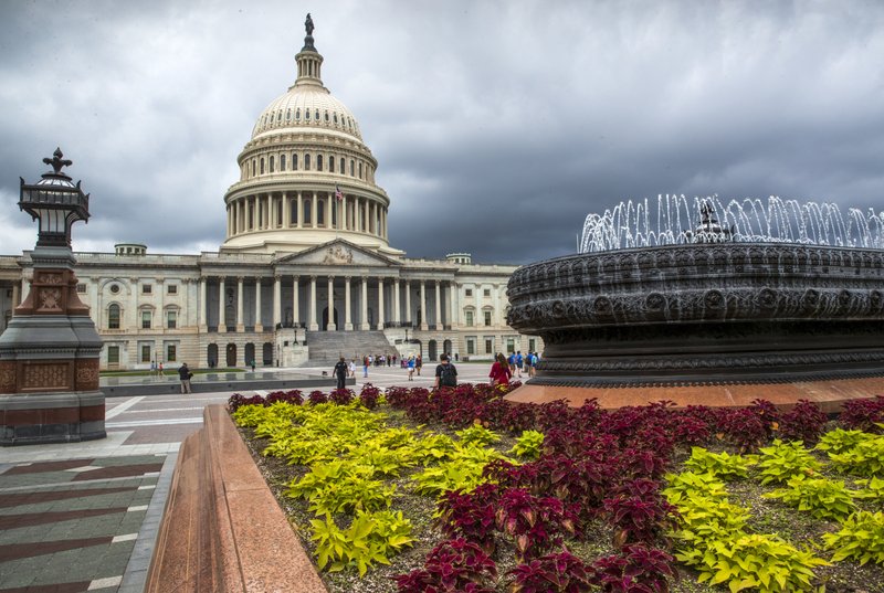 FILE- In this May 30, 2018, file photo the East Front of the U.S. Capitol in Washington is seen under stormy skies. The federal government piled up a record deficit in April, traditionally a month of big budget surpluses. The sea of red ink is being created by a drop in revenue and a massive increase in spending to fund efforts to deal with the coronavirus pandemic. The Treasury Department said Tuesday, May 12, 2020 that the government racked up a shortfall of $737.9 billion last month. That was more than three times larger than the previous record monthly deficit of $235 billion set in February. (AP Photo/J. Scott Applewhite, File)
