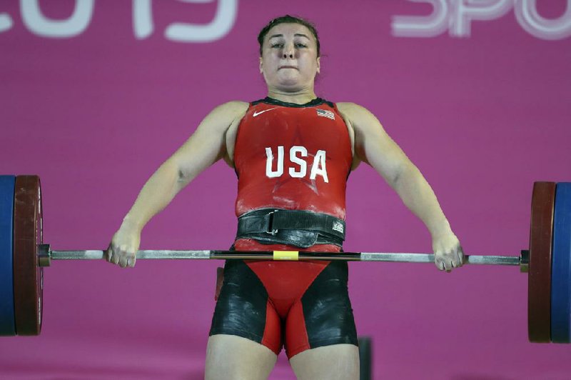 Kate Nye of the United States, shown competing in women’s weightlifting at the Pan American Games in Lima, Peru, in 2019, is one of many athletes forced to be creative during the coronavirus pandemic. She is currently training in her garage. (AP/Fernando Llano) 