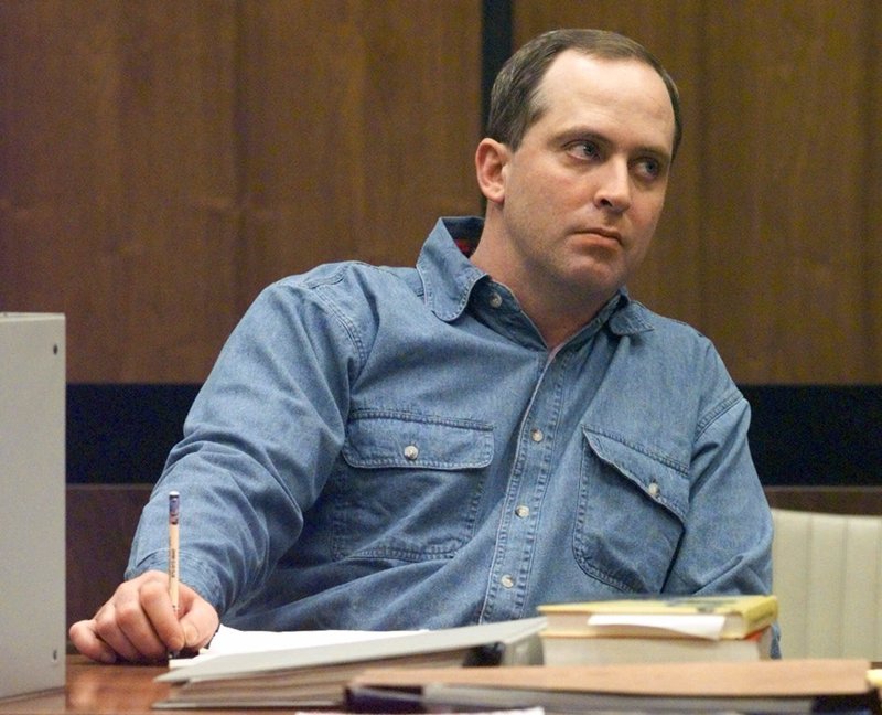 In this file photo Robert Todd Burmingham watches proceedings during jury selection for his trial Monday, Nov. 16, 1998, at the Cross County Court House in Wynne, Ark. Burmingham is accused of using a flashing blue light on a car to pull female motorists over and then assaulting them. (AP Photo/Danny Johnston)