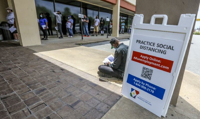 A man fills out paperwork outside the Arkansas Workforce Center at 5401 S. University Ave. in Little Rock on Wednesday morning.
(Arkansas Democrat-Gazette/John Sykes Jr.)