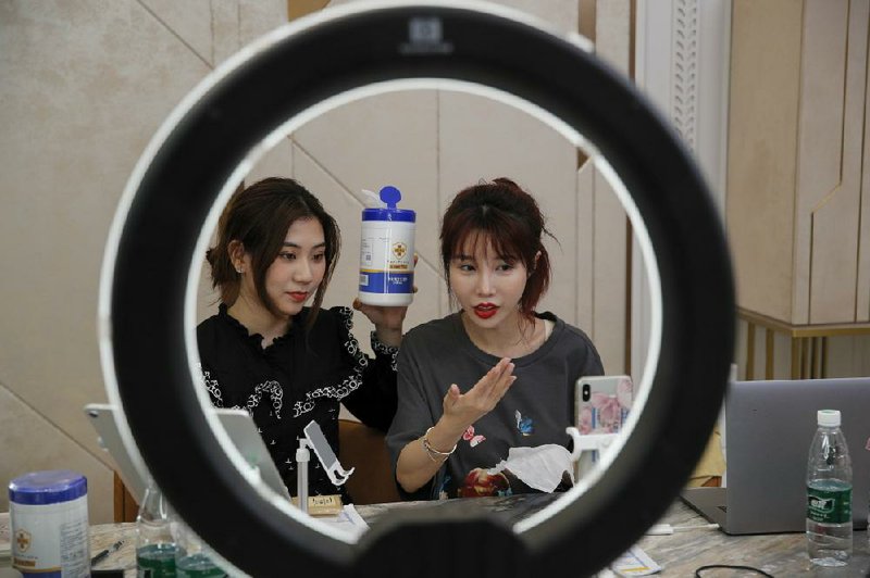 Chinese online celebrity Zhang Mofan (right) sells disinfectant wipes to her online clients via livestreaming at her house in Beijing.
(AP/Andy Wong)