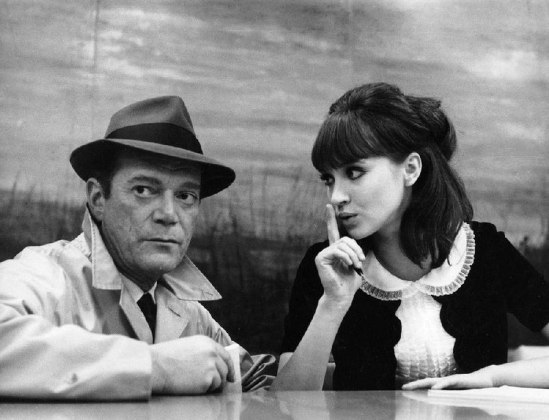 Detective Lemmy Caution (American émigre Eddie Constantine) is cautioned by Natacha von Braun (Anna Karina) in Jean-Luc Godard’s science fiction film noir Alphaville (1965).
