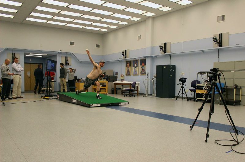 Central Connecticut State pitcher Michael DeLease throws off a smart mound earlier this year at the Center for Motion Analysis in Farmington, Conn. The new technology allows scientists to study pitching mechanics to enhance efficiency and prevent injuries.
(AP/Pat Eaton-Robb)