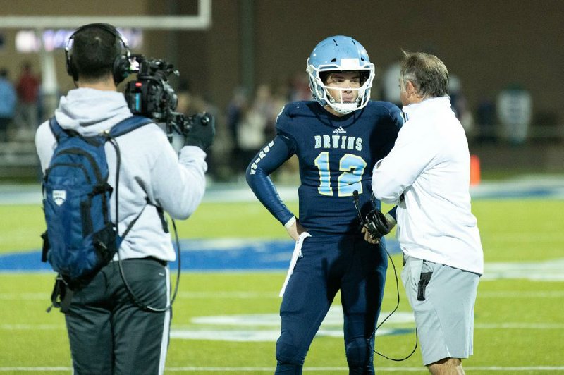 Steve Raum (left), a producer for the digital sports network Overtime, films Pulaski Academy Coach Kevin Kelley (right) speaking with quarterback Braden Bratcher during a 2019 playoff game for the series To the House. The series, which follows the team’s Class 5A state championship run, debuted last Saturday with the first of 15 episodes on Overtime’s YouTube profile, Overtime SZN.
(Arkansas Democrat-Gazette/Justin Cunningham)