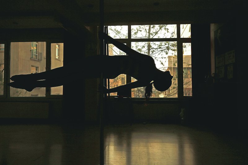 Tuba Parlak, 39, a pole dancing performer and instructor, warms-up April 30 at her studio in Istanbul, as she prepares for an online training session for students at home, due to the coronavirus restrictions. (AP/Emrah Gurel)