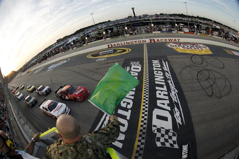 FILE - In this May 11, 2012, file photo, drivers take the green flag for the start of the NASCAR Nationwide Series auto race at Darlington Raceway in Darlington, S.C. NASCAR will re-fire the engines moments after mask-clad drivers climb into their cars at Darlington Raceway. The season will resume Sunday May 17, 2020, without spectators and drivers will have no practice before they pull away from pit road for the first time in more than two months. (Tyler Barrick/Pool Photo via AP, File)