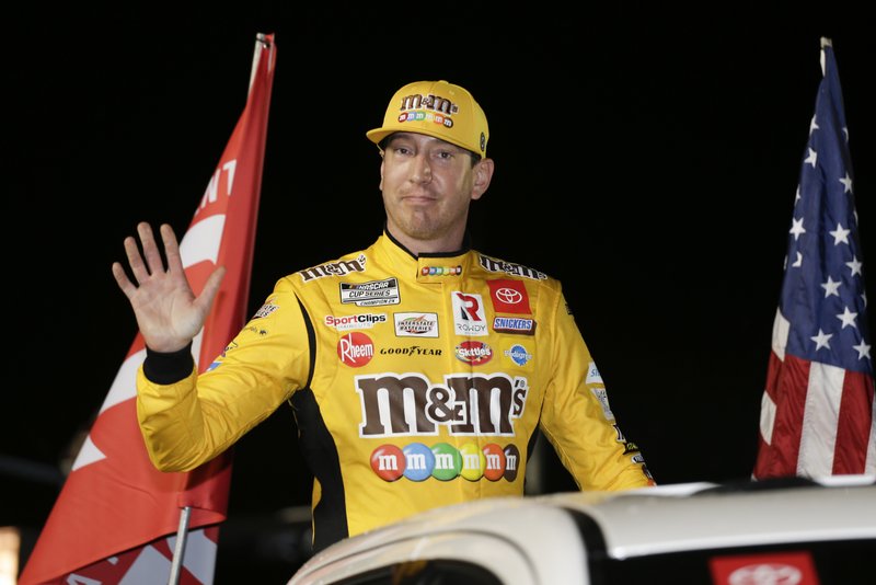 In this Feb. 13, 2020, file photo, Kyle Busch waves to fans during driver introductions for the first of two Daytona 500 qualifying auto races at Daytona International Speedway in Daytona Beach, Fla.  (AP Photo/Terry Renna, File)