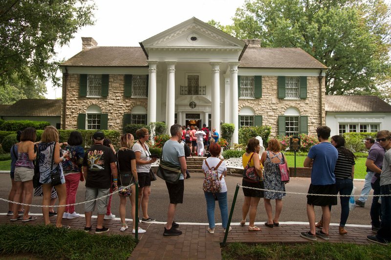Fans wait in line outside Graceland, Elvis Presley's Memphis home, in this Aug. 15, 2017, file photo.