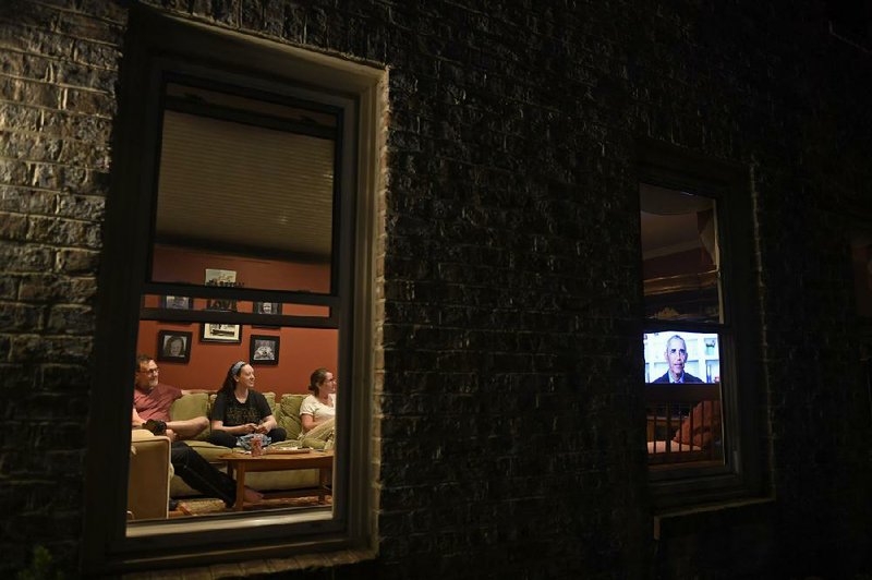 High school senior Isabel McGuire (center) watches Saturday night with her parents Mickey and Catherine McGuire at their home in Edgewater, Md., as former President Barack Obama delivers a televised commencement address to the nation’s high school Class of 2020. In his speech and in an earlier address to graduates of historically black colleges and universities, he took aim at the nation’s leaders over their handling of the coronavirus crisis. “A lot of them aren’t even pretending to be in charge,” he said.
(AP/Susan Walsh)