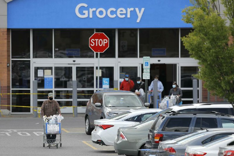 A shopper leaves a Walmart store last week in Cockeysville, Md. Walmart said recently that it “proactively rolled out many safety measures” was not yet not putting “a timetable on making modifications.”
(AP/Julio Cortez)