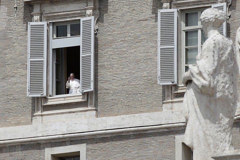 Pope Francis gives his blessing from his studio's window overlooking St. Peter Square at the Vatican on Sunday, May 17, 2020. (AP Photo/Alessandra Tarantino)