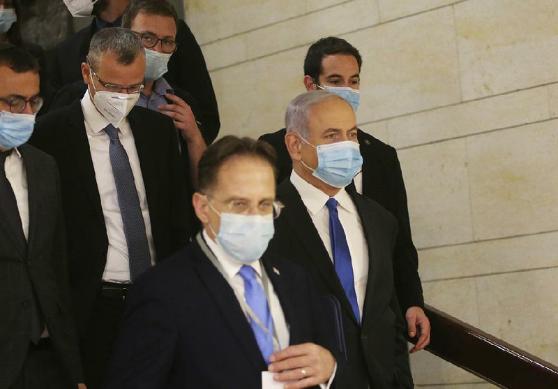 Israeli Prime Minister Benjamin Netanyahu (second from right) makes his way to the swearing-in ceremony for his new government Sunday at the Knesset building in Jerusalem. (AP/Alex Kolomiensky) 