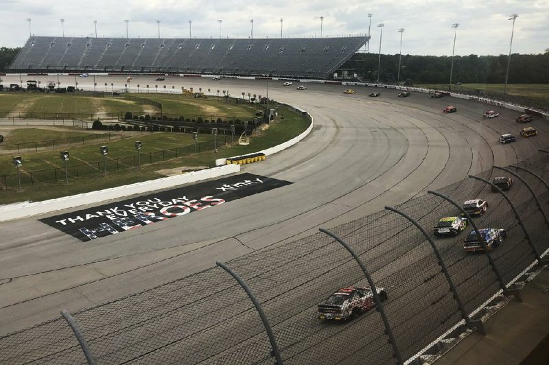 Cars go past the empty grandstands at Darlington Raceway during the NASCAR
first since the sport was shut down because of the coronavirus pandemic in March. (AP/Jenna Fryer)