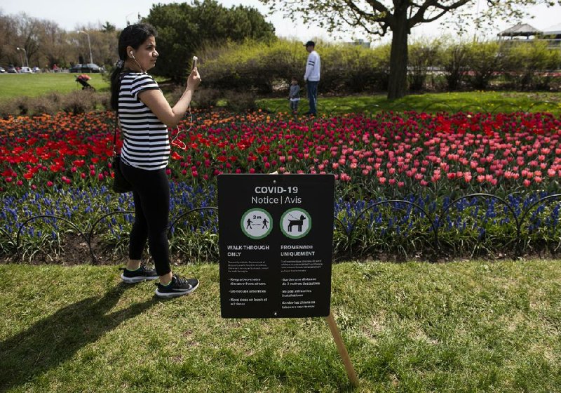 People at Commissioners Park in Ottawa, Ontario, admire the flowers Sunday during the Canadian Tulip Festival. (AP/The Canadian Press/Justin Tang) 