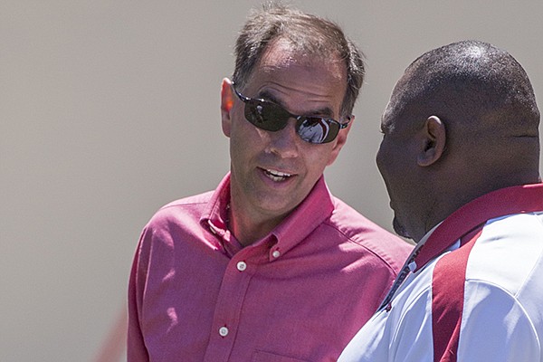 University of Arkansas deputy athletics director Jon Fagg (facing) talks with football staffer EK Franks prior to a scrimmage Saturday, April 25, 2015, in Fayetteville. University of Arkansas deputy athletics director Jon Fagg (facing) talks with football staffer EK Franks prior to a scrimmage Saturday, April 25, 2015, in Fayetteville.