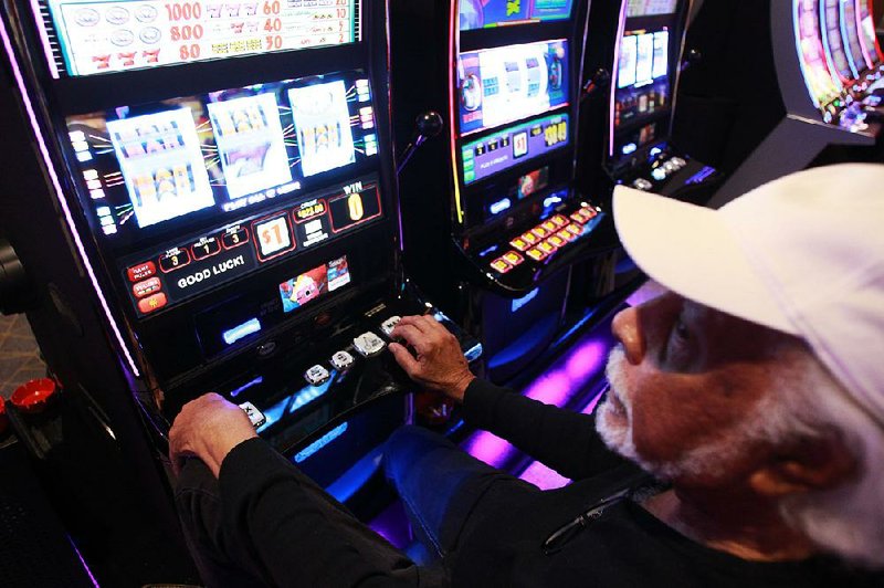 FILE — Edward Fontenette of Pine Bluff racks up more than $800 in winnings on one of the slot machines on opening night of the Saracen Casino Annex in this Sept. 27, 2019 file photo.