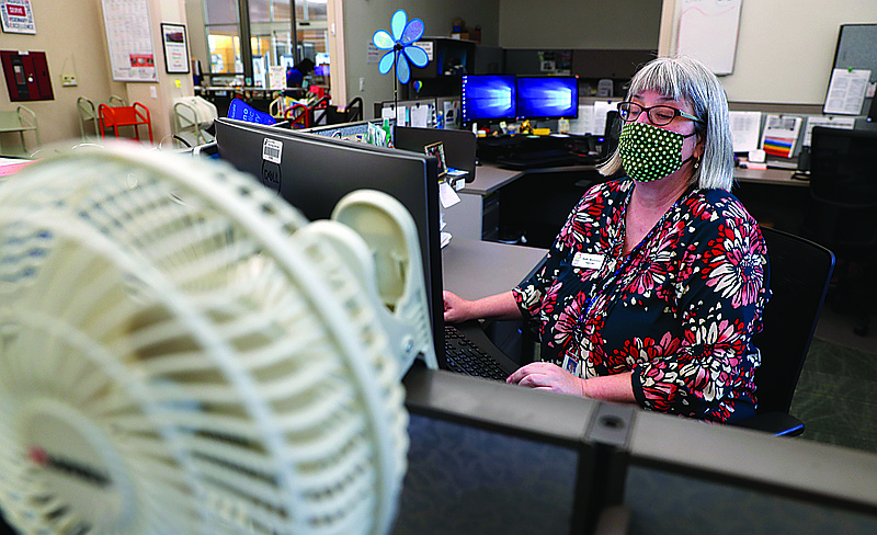 Associated Press
Librarian Holly Ryckman looks up the phone number for 81-year-old Dell Kaplan before calling her in Plano, Texas Friday, May 15, 2020. Ryckman is participating in a program that have popped up across the U.S. during the pandemic to help older adults with a simple offer to engage in small talk. Ryckman said the calls have been "a gift" for her. story.lead_photo.caption