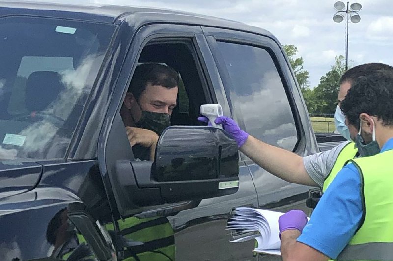 Ryan Newman gets his temperature taken as he arrives at Darlington Raceway before the Real Heroes 400 race on Sunday. NASCAR, which had been idle for 10 weeks during the coronavirus pandemic, has instituted several safety measures for drivers and teams. (AP/Jenna Fryer) 