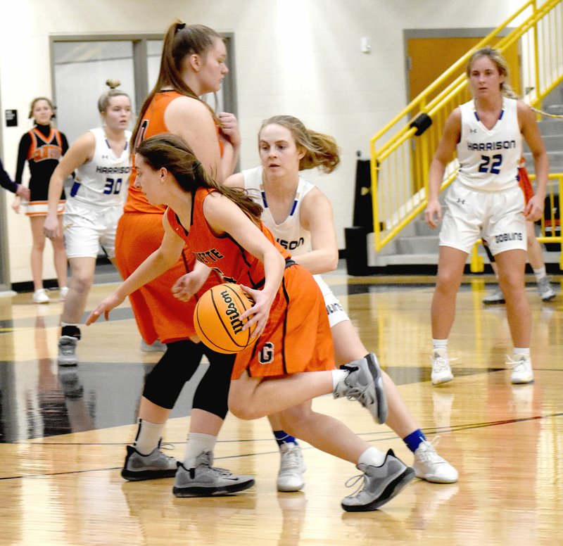 MARK HUMPHREY ENTERPRISE-LEADER Gravette senior Shylee Morrison runs the Harrison defender guarding her through a screen. Morrison scored 14 points before sustaining an injury during a 42-26 loss Gravette experienced on Thursday, Feb. 20, at the District 4A-1 tournament semifinal hosted by Prairie Grove Feb. 17-22.