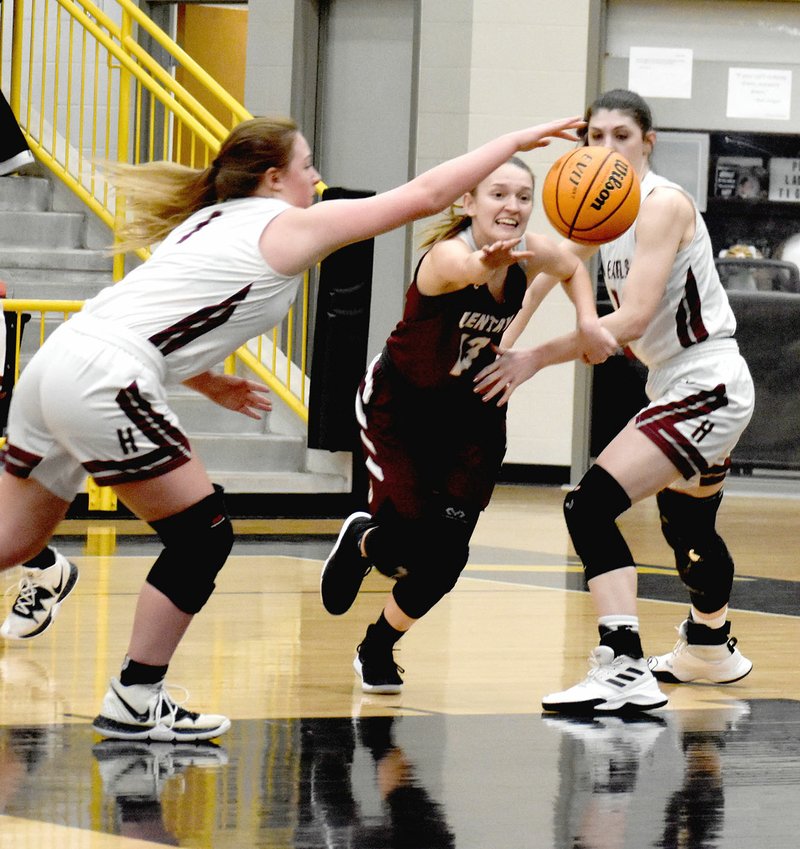 MARK HUMPHREY ENTERPRISE-LEADER Gentry senior Ariel Nix battles a pair of Huntsville players for control of a loose ball in the lane. The Lady Pioneers lost to the Lady Eagles, 52-39, to exit out of the District 4A-1 girls basketball tournament hosted by Prairie Grove on Tuesday, Feb. 18.