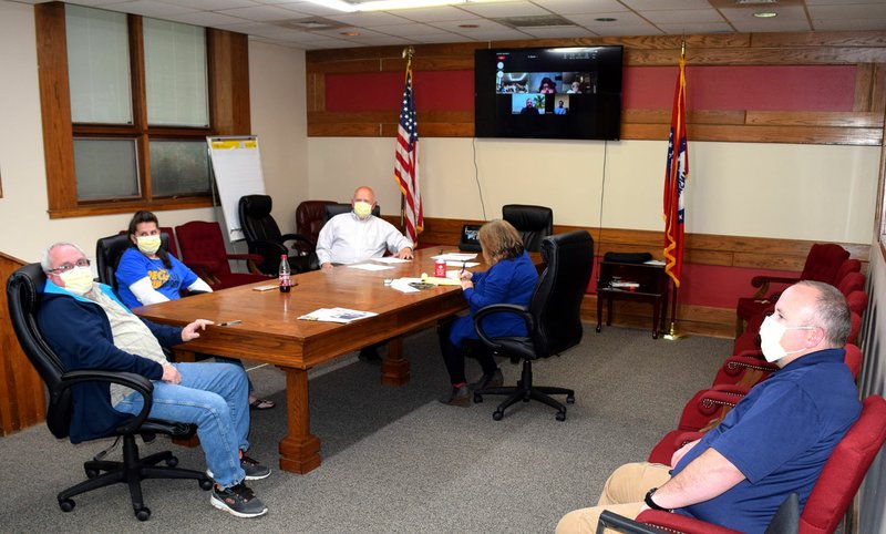 Westside Eagle Observer/MIKE ECKELS The Decatur city council observes covid-19 protocol during its May 11 meeting in the conference room at city hall. Council members James Jensen (right), Danny Harrington (left), Sandy Duncan, Mayor Bob Tharp, and City Clerk Kim Wilkins were joined via Zoom by Ladale Clayton, Linda Martin, city attorney Michael Nutt, and fire chief Jeremy Luker.