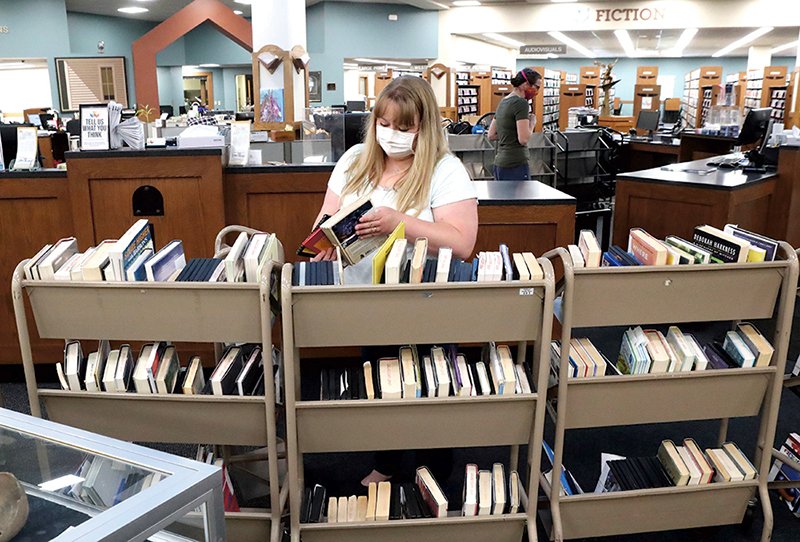 Garland County Library employee Brittany Chavez sorts books at the library Tuesday, May 19, 2020. - Photo by Richard Rasmussen of The Sentinel-Record