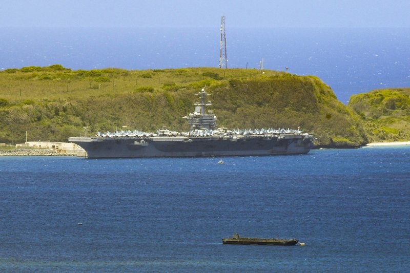 FILE - In this April 3, 2020, file photo, the USS Theodore Roosevelt, a Nimitz-class nuclear powered aircraft carrier, is docked along Kilo Wharf of Naval Base Guam. The USS Theodore Roosevelt will return to sea later this week, the ship's captain said Monday night, May 18, nearly two months after the aircraft carrier pulled into Guam with a rapidly growing outbreak of the coronavirus. (Rick Cruz/The Pacific Daily via AP, File)