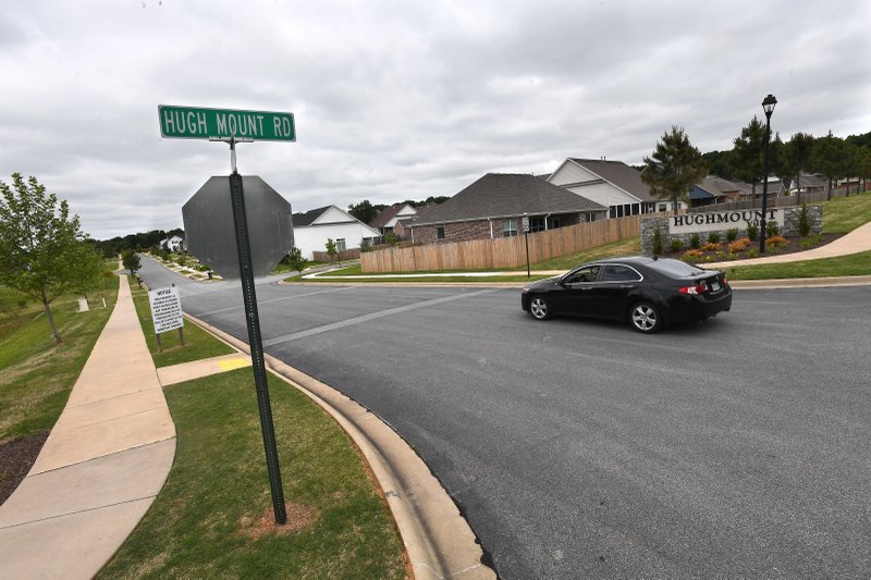 A car turns west Tuesday onto Canyon Run Dr. from Hugh Mount Road in Fayetteville. The City Council considered a request to annex and rezone about 152 acres near Hughmount Road. (NWA Democrat-Gazette/J.T. Wampler)