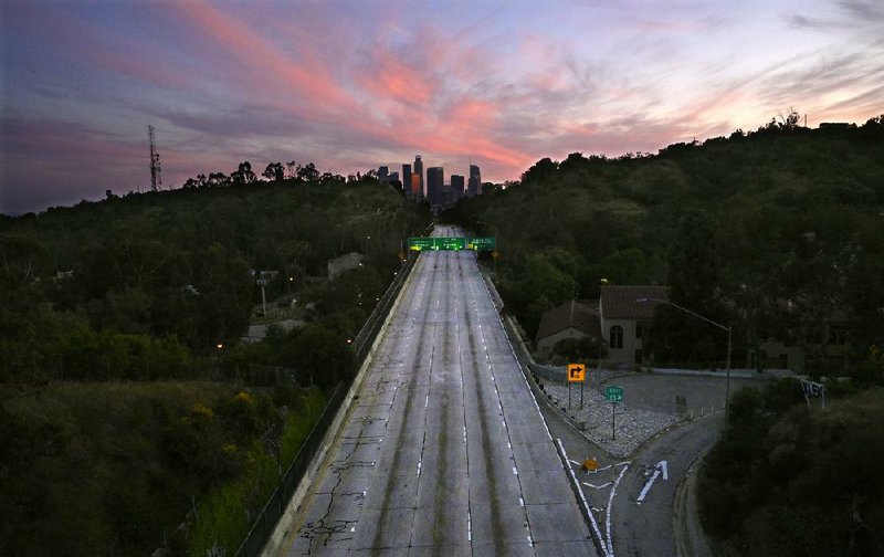 The 110 Arroyo Seco Parkway that leads to downtown Los Angeles is free of traffic in this photo taken April 26. The sudden drop-off in driving, ying and industrial output helped reduce carbon dioxide emissions dramatically in recent months, researchers see it as just “a blip” in the long term. (AP/Mark J. Terrill) 
