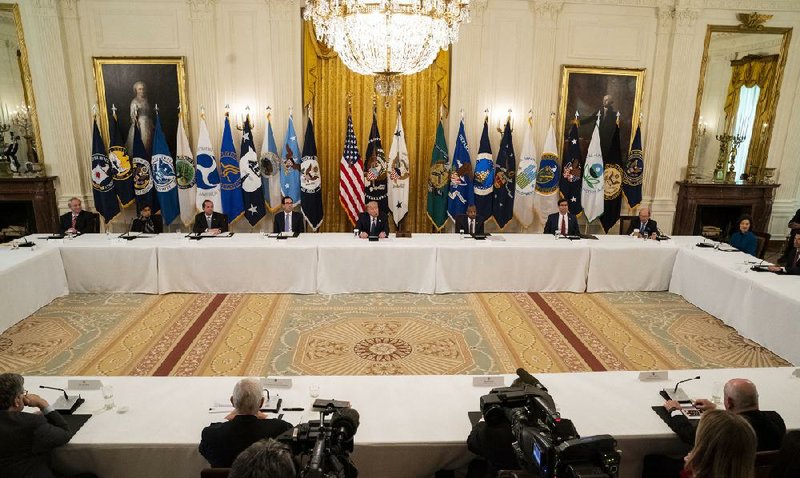 President Donald Trump (center) leads a Cabinet meeting Tuesday at the White House. (Doug Mills/The New York Times) 
