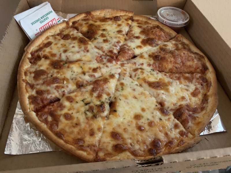 Pizza D'Action puts a thick layer of cheese and a thinner layer of red sauce on its Cheezy Peezy pizza. (Arkansas Democrat-Gazette/Eric E. Harrison)

