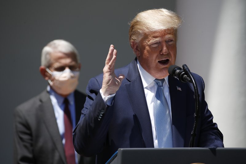 President Donald Trump speaks about the coronavirus in the Rose Garden of the White House, Friday, May 15, 2020, in Washington. Director of the National Institute of Allergy and Infectious Diseases Dr. Anthony Fauci listens at left. (AP Photo/Alex Brandon) story.lead_photo.caption
