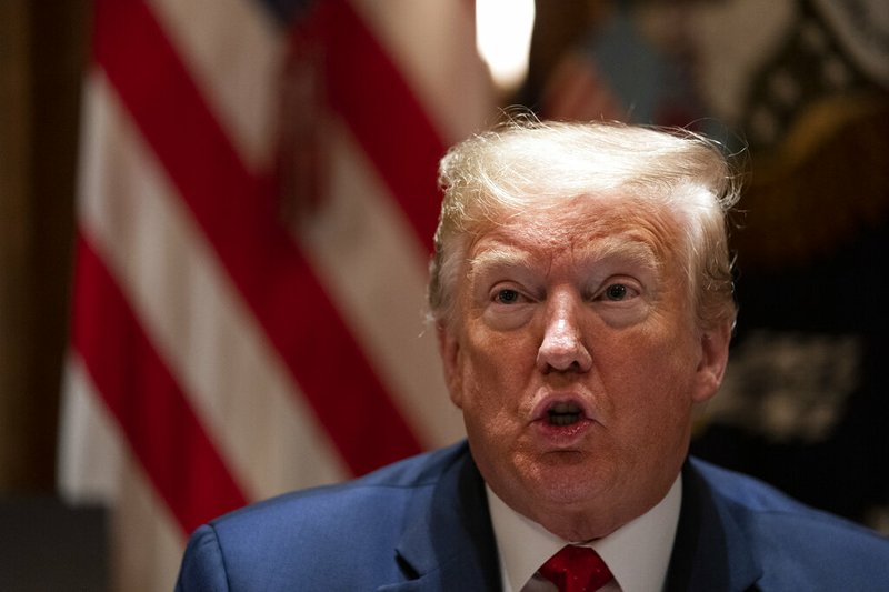 President Donald Trump speaks during a meeting with Arkansas Gov. Asa Hutchinson, and Kansas Gov. Laura Kelly, in the Cabinet Room of the White House, Wednesday, May 20, 2020, in Washington. (AP Photo/Evan Vucci)