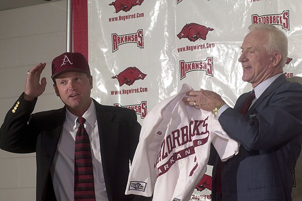Arkansas baseball coach Dave Van Horn (left) is introduced by athletics director Frank Broyles at a news conference Friday, June 21, 2002, at Bud Walton Arena in Fayetteville.